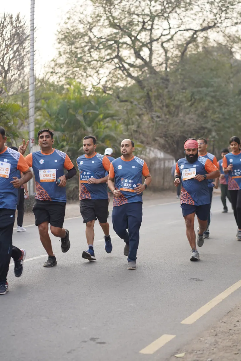Runners keeping pace on the tree-lined SPPU campus road